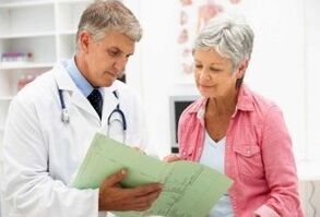 Doctor making appointment with woman with arthritis
